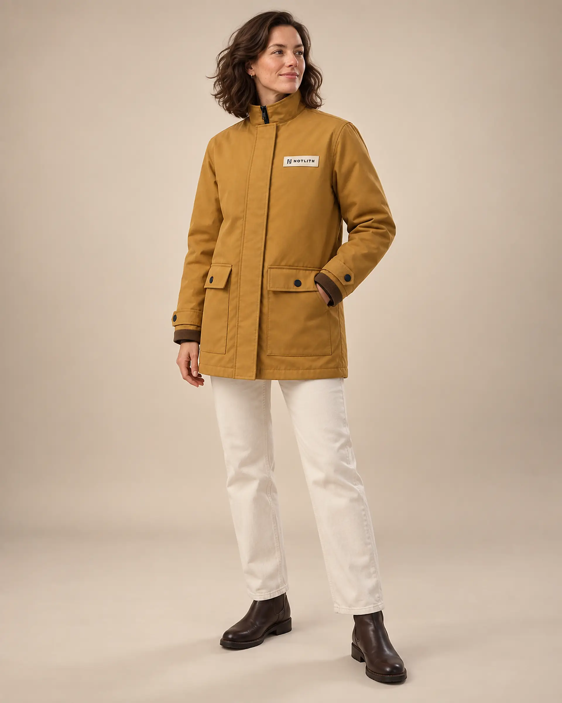 femme portant une veste ocre debout sur fond clair